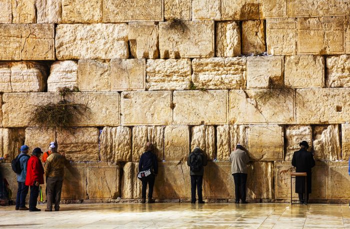 The Western Wall in Jerusalem, Israel in the night JERUSALEM - DECEMBER 15: The Western Wall in the night with a praying pilgrims on December 15, 2013 in Jerusalem. It's located in the Old City of Jerusalem at the foot of the western side of the Temple Mount.