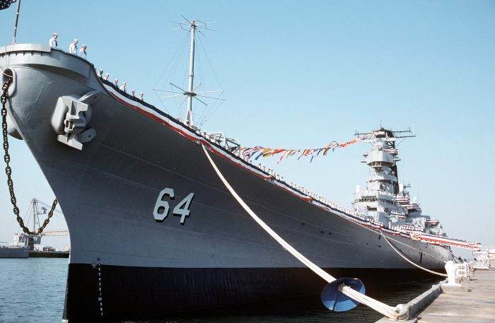 DN-ST-92-03155 Crew members man the rails aboard the battleship USS WISCONSIN (BB-64) during the vessel's decommissioning ceremony.